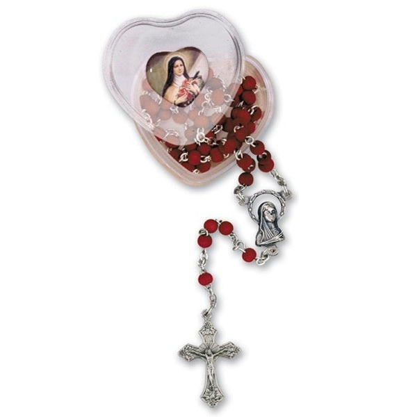 Red wood rosary with silver cross in a heart-shaped box on a white background
