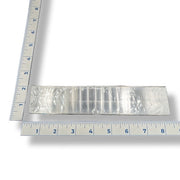 A selenite ruler 6-inches in length with a ruler for scale on a white background
