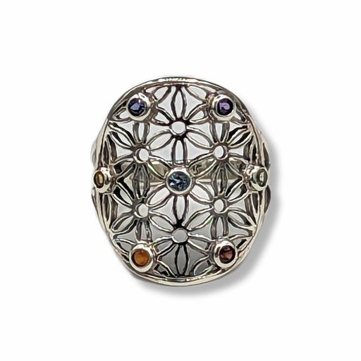Silver ring with floral design and embedded gemstones on a white background