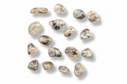 A group of  tumbled gemstones in clear, beige, and gray tones, arranged on a plain white background with soft drop shadows.
