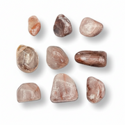 Hematoid quartz tumbled on a white background