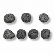 Set of eight black volcanic stones on a white background