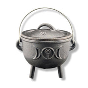 Black cast iron cauldron with lid on a white background