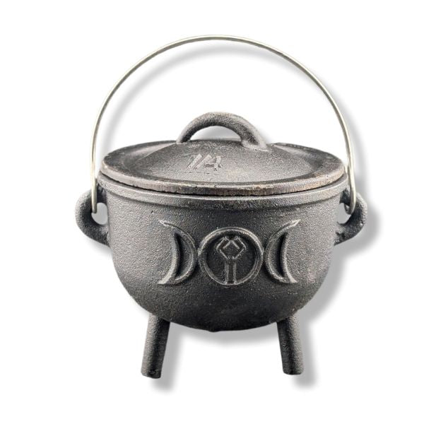 Black cast iron cauldron with lid on a white background