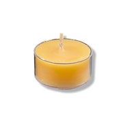 Yellow candle in a clear glass holder on a white background
