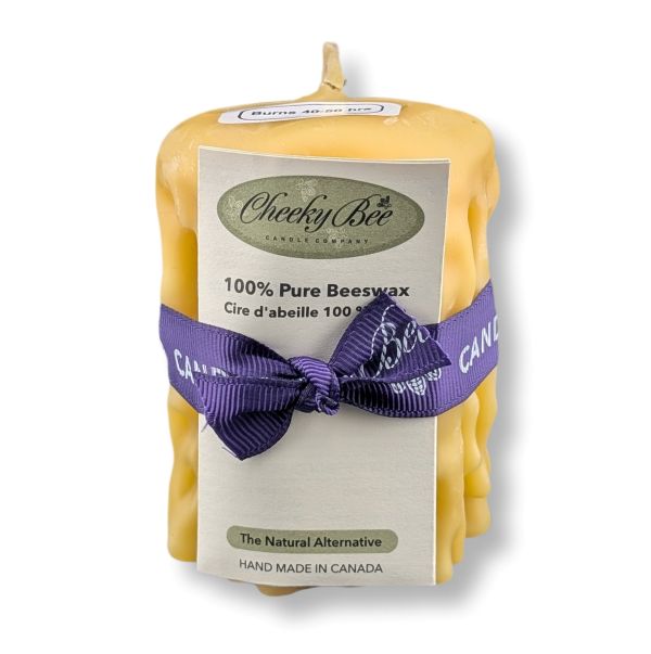 Beeswax candle with a purple bow and 'Cheeky Bee' label on a white background