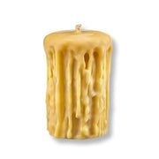Beeswax candle with textured surface on a white background