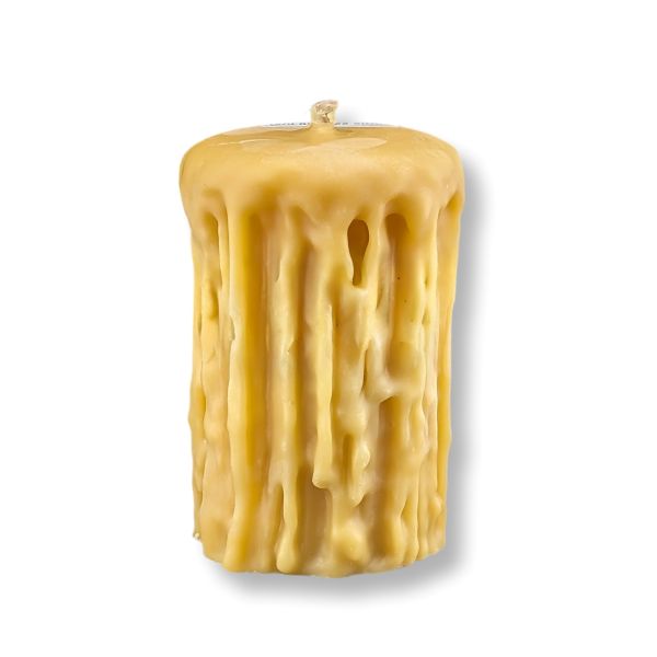 Beeswax candle with textured surface on a white background