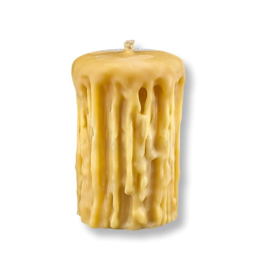 Beeswax candle with textured surface on a white background