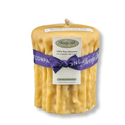 Beeswax candle with a purple ribbon and Cheeky Bee label on a white background