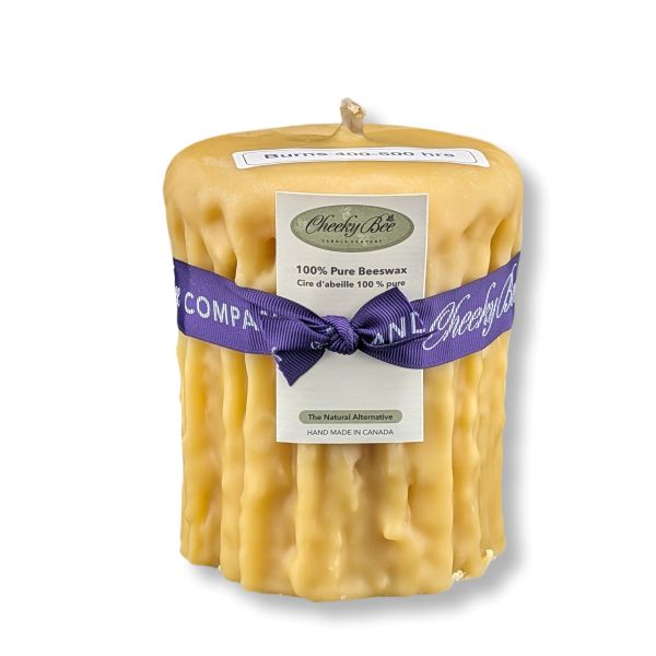 Beeswax candle with a purple ribbon and Cheeky Bee label on a white background