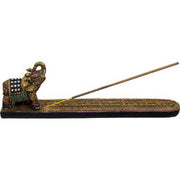 A decorative brass incense holder with an elephant figurine on a white background