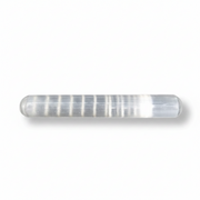 A cylindrical selenite with rounded ends, photographed on a white background with a soft shadow.
