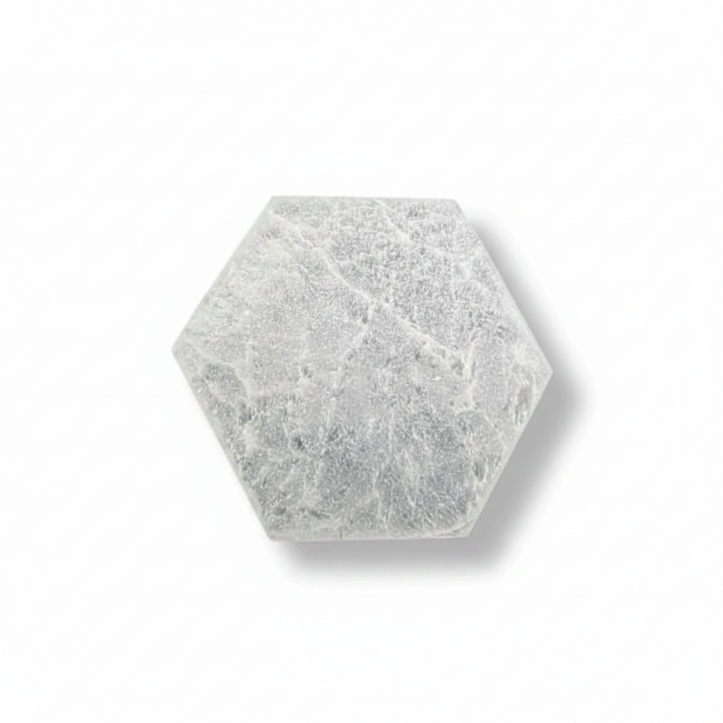 A hexagonal selenite plate, shown on a clean white background with a soft drop shadow.