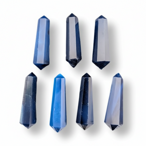 Six faceted crystal points in various shades of blue, arranged in two rows on a white background with soft drop shadows.