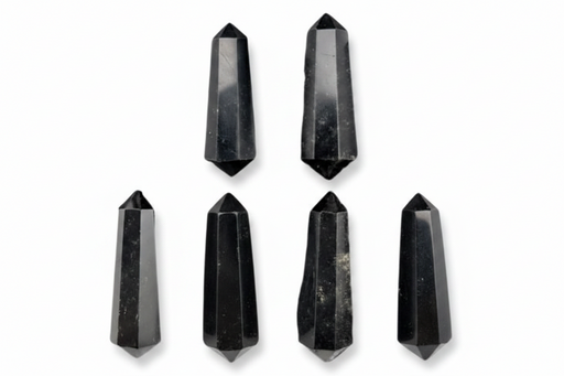 Six black crystal points of varying heights arranged on a plain white background.