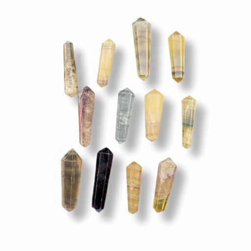 Nine polished fluorite points in various natural colors and patterns, arranged in a loose circle on a white background with soft drop shadows.