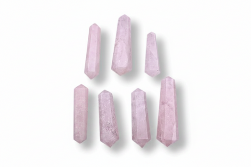 Seven pale pink crystal points arranged in two rows on a plain white background.