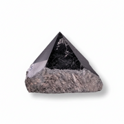 Pyramidal stone crystal on a white background