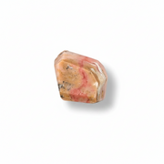 Polished pink opal crystal on a white background