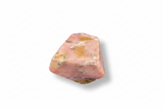 Pink stone with brown inclusions on a white background
