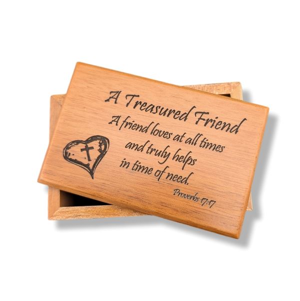 Wooden box with engraved text and heart design on a white background