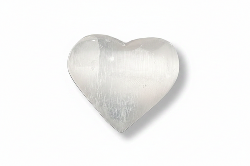 A polished heart-shaped selenite with a smooth, lustrous surface and subtle striations, shown on a plain white background with a soft drop shadow.