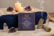 11.11 Oracle card set with candles, crystals, and smudge sticks on a table.
