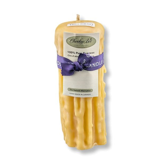 Beeswax candle with a purple ribbon and 'Cheeky Bee' label on a white background
