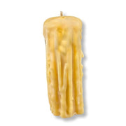 Textured yellow candle on a white background