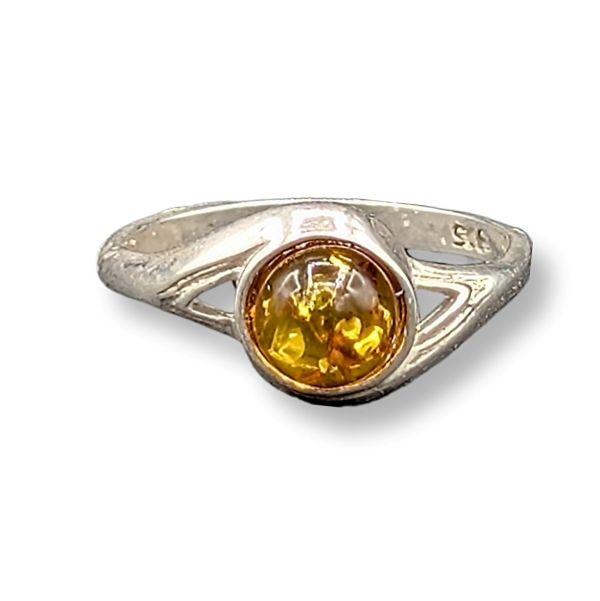 Silver ring with a yellow gemstone on a white background