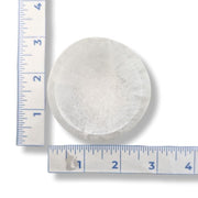 A round, Selenite 6cm bowl, next to two blue-and-white rulers for scale on a white background.