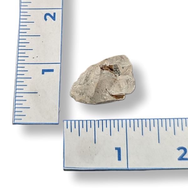 Rock next to a ruler on a white background
