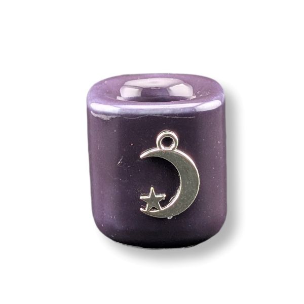 A purple cylindrical candle holder  featuring a silver crescent moon and star pendant, shown on a white background with a soft shadow.