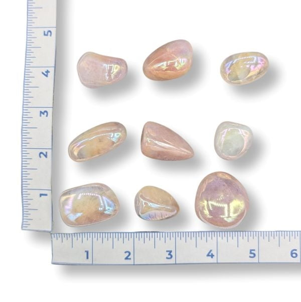 Iridescent stones on a white background with a ruler for scale.