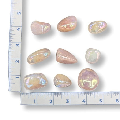 Iridescent stones on a white background with a ruler for scale.