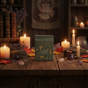Book titled 'Practical Witch's Spell Deck' on a wooden table with candles and herbs in a mystical setting.