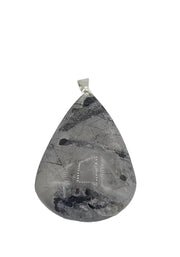 Teardrop-shaped stone pendant with a silver bail on a white background