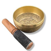 Singing bowl with wooden striker on a white background