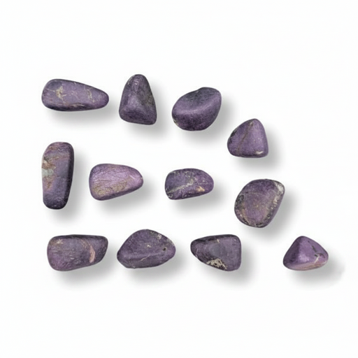 Purple stones arranged in a scattered pattern on a white background