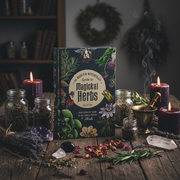 Book titled 'Modern Witch's Guide to Magickal Herbs' on a wooden table with herbs and candles.