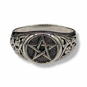 Silver ring with pentagram design on a white background