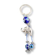 Keychain with elephant and eye-shaped beads on a white background