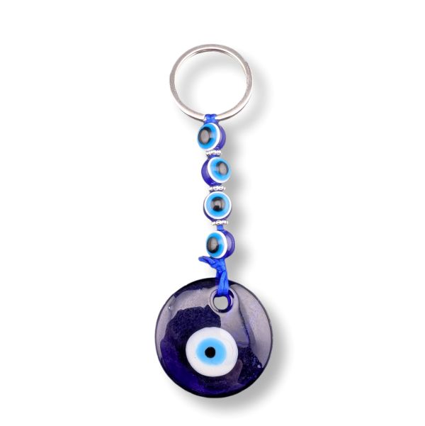 Keychain with blue evil eye design on a white background