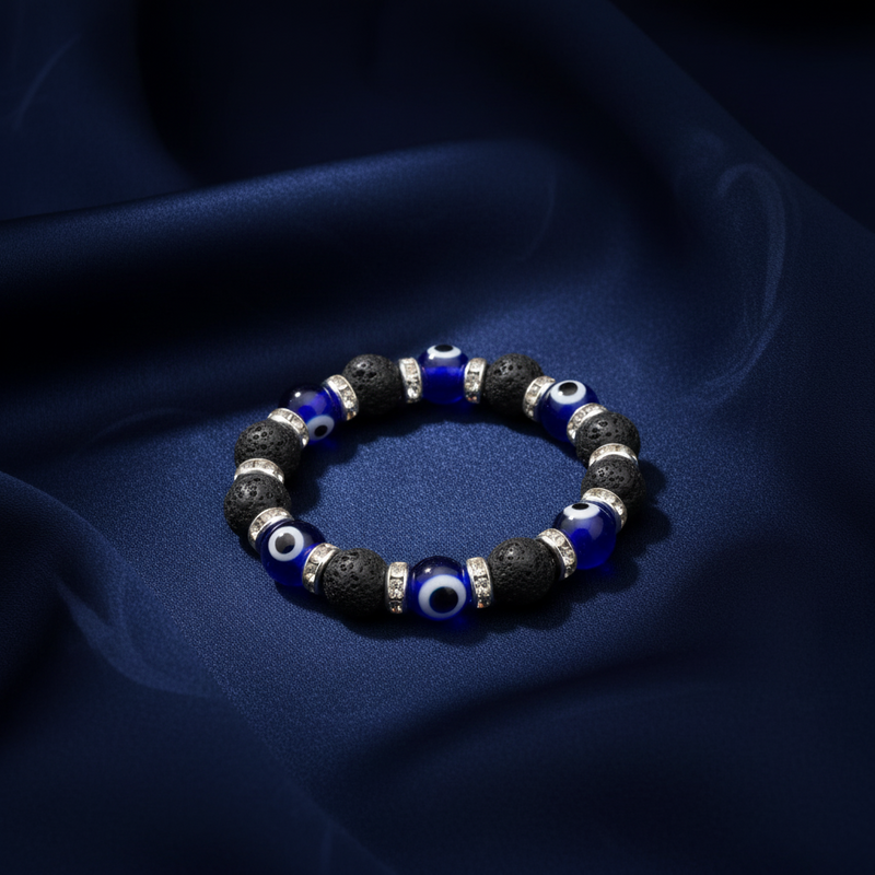 Bracelet with blue and black beads on a dark fabric background