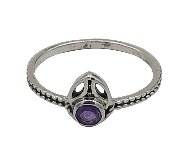 Silver ring with a purple gemstone on a white background