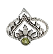 Silver ring with a green gemstone on a white  background
