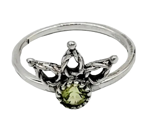 Silver ring with a green gemstone on a white  background