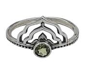 Silver ring with a green gemstone on a white background