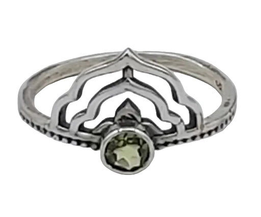 Silver ring with a green gemstone on a white background